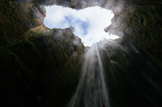 waterfall into cave, looking up to sky